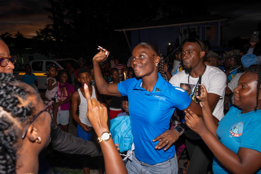 Julian Alfred, center, who won the 100-meter Olympic gold in Paris, is celebrated upon returning to Saint Lucia after winning the country's first Olympic medal, in Castries, Saint Lucia, Tuesday. (AP)