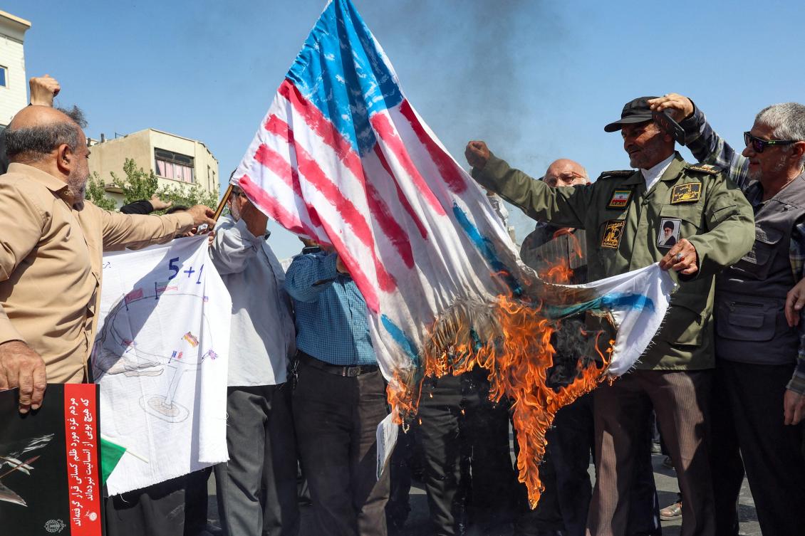 Iranians burn Israeli and US flags during an anti-Israel protest in Tehran on Sept. 27, 2024. (AFP)