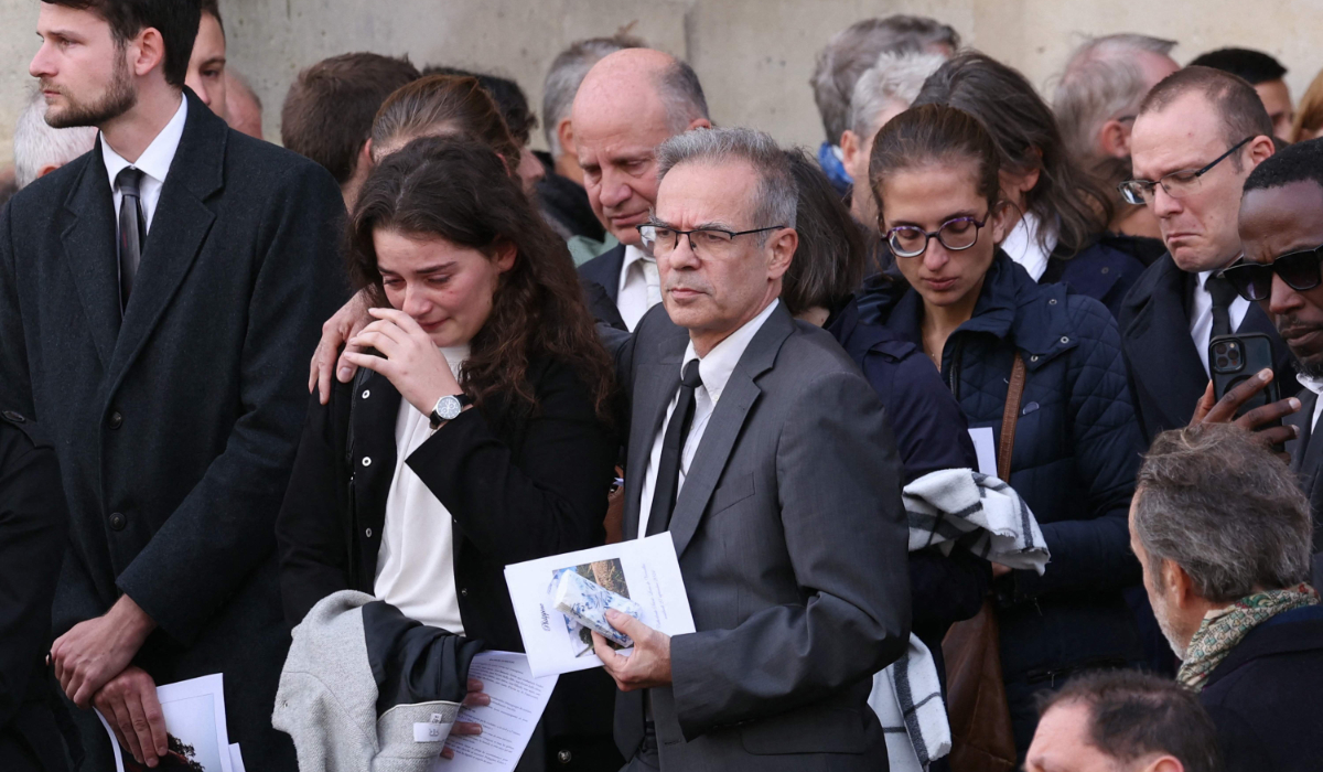 Relatives of Philippine, a French student, whose body was found buried nearly a week ago cry after her funeral ceremony at Versailles' cathedral near Paris, on September 27, 2024. (AFP)