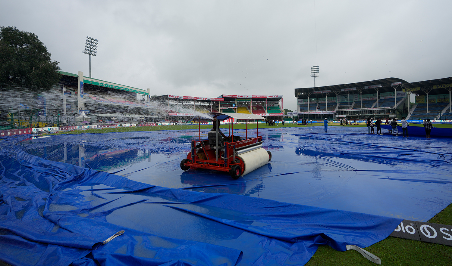 Groundsman removes water from the outfield before the start of the second cricket test match between Bangladesh and India at the Green Park stadium in Kanpur, India, on September 27, 2024. (AP)