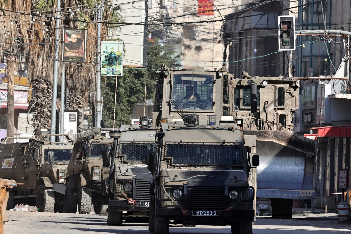 Israeli army vehicles drive in a street during an army raid in Jenin in the occupied West Bank on September 25, 2024. (AFP)