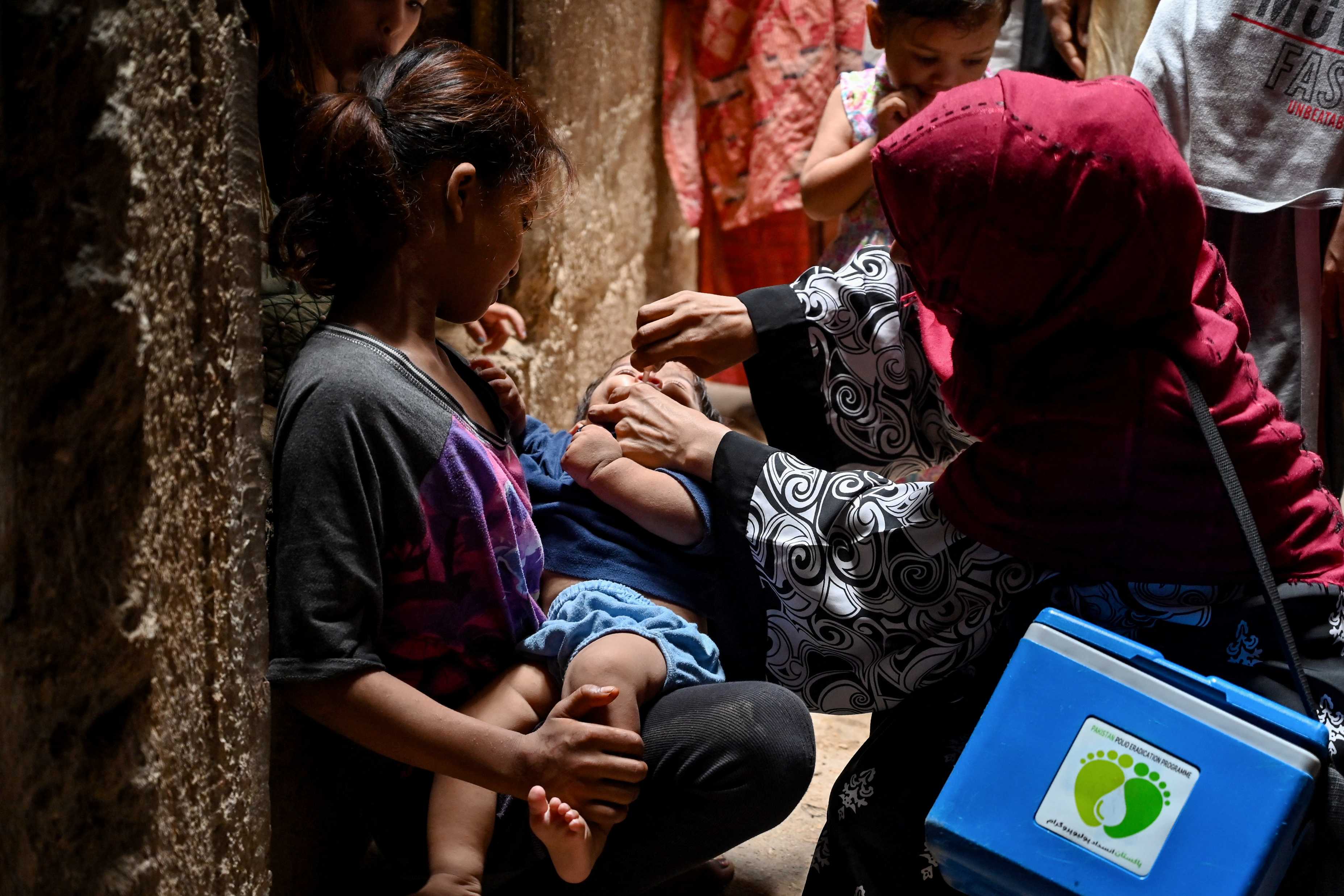 A health worker administers polio vaccine drops to a child during a polio vaccination campaign in Karachi. (AFP)