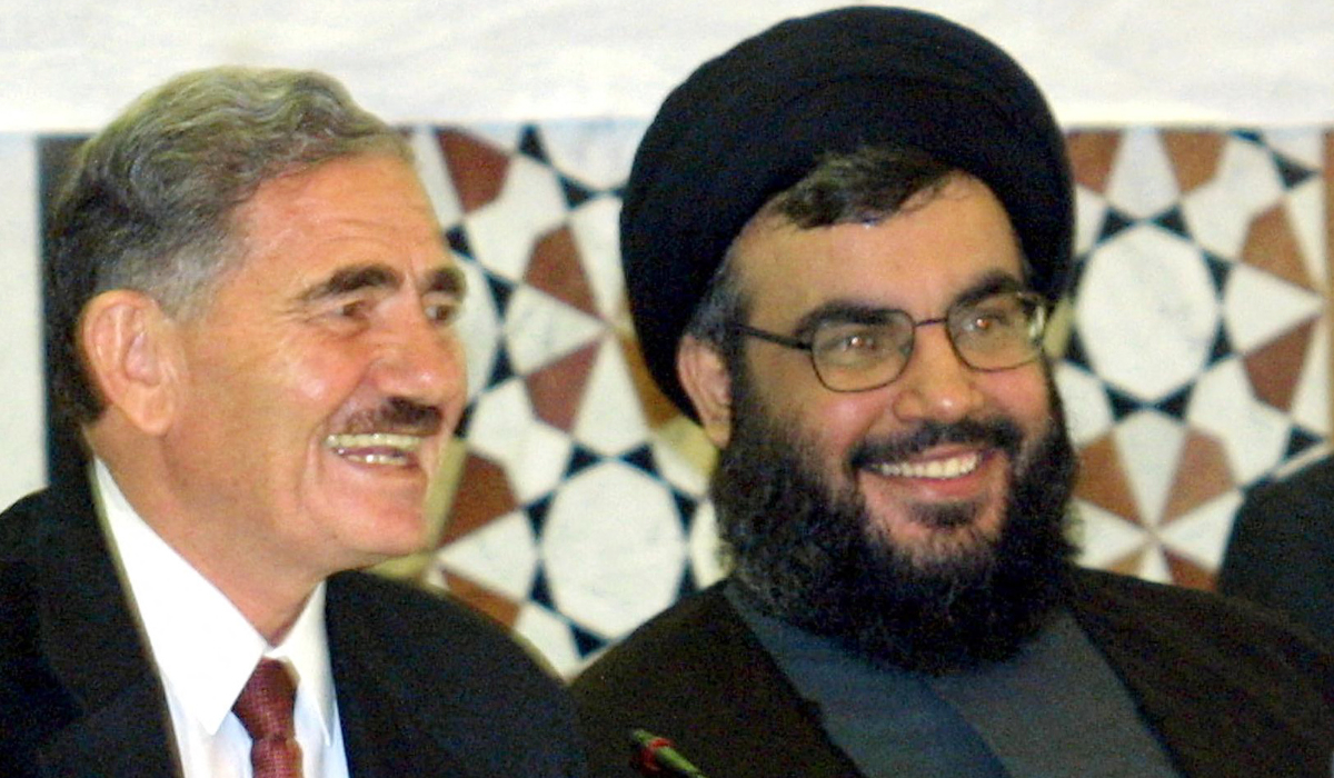 Sheikh Hasan Nasrallah, Secretary General of the Hezbollah (R) shares a light moment with Abdullah al-Ahmar deputy Secretary General of the Syrian ruling Baath party during a conference of extremist Arab and Islamist movements in Damascus on September 27, 2001. (AFP)