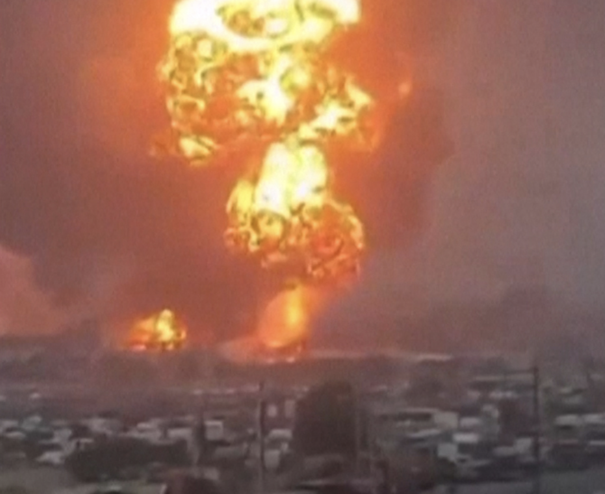 An image grab taken from a UGC video posted on social media on September 29, 2024, shows smoke billowing above Hodeida port city following Israeli strikes. (AFP)
