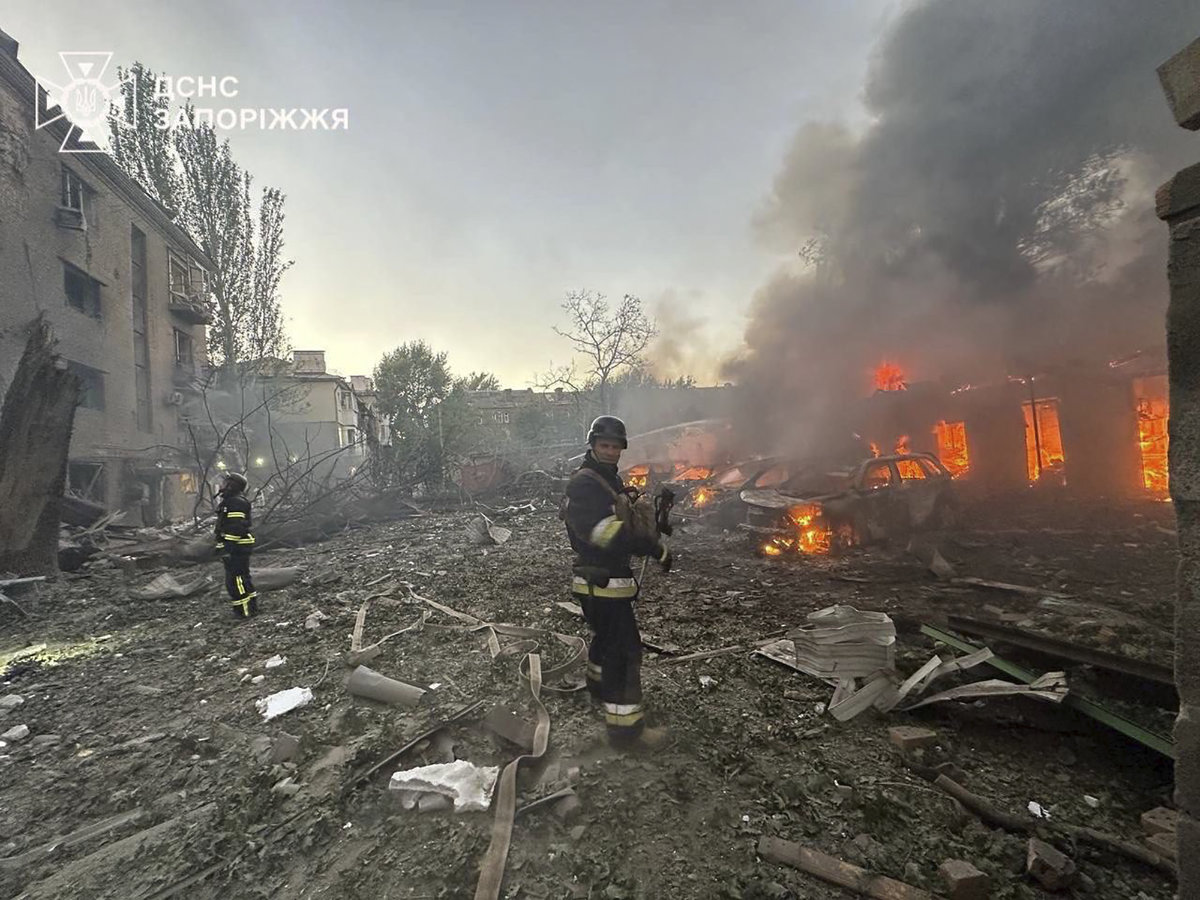 In this photo provided by the Ukrainian Emergency Service, firefighters put out the fire after Russia attacked the city with guided bombs overnight in Zaporizhzhia on Sept. 29, 2024. Russian forces later struck Kyiv early Monday. (Ukrainian Emergency Service via AP)