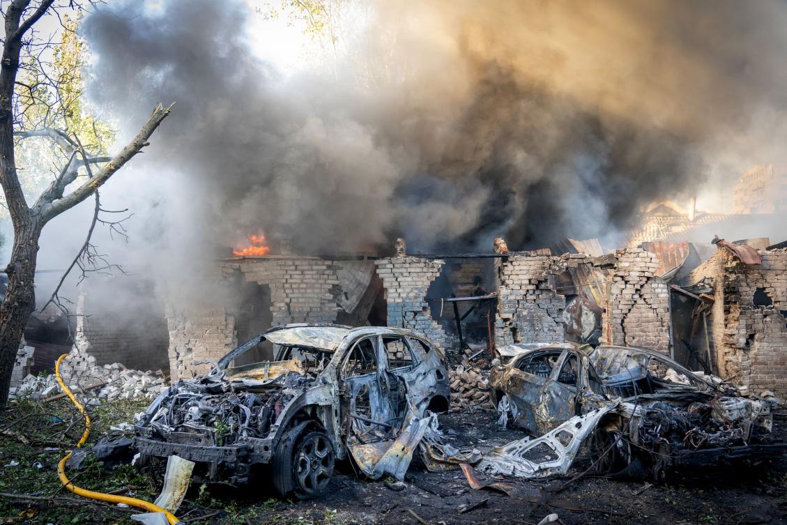 This handout photograph taken and released by the Zaporizhzhia Regional Military Administration on September 29, 2024 shows burnt-out cars next to a burning building following a missile attack in Zaporizhzhia (AFP)