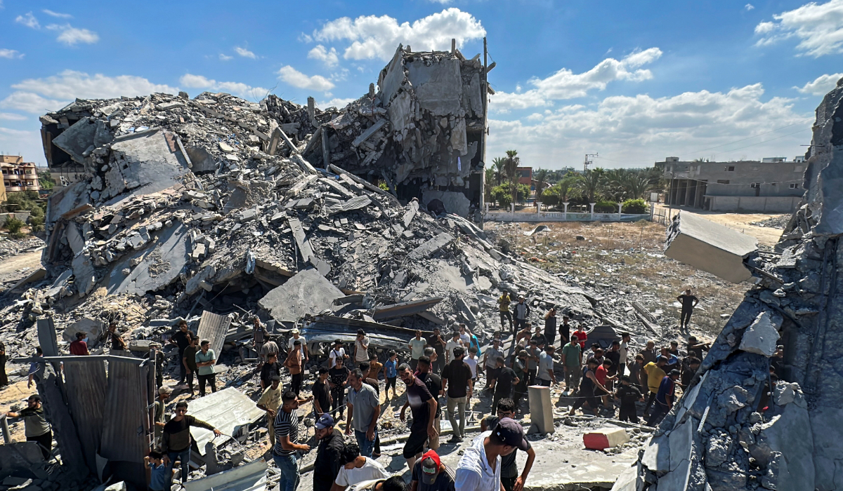 Palestinians gather at the site of an Israeli strike on a residential building, amid the Israel-Hamas conflict, in Nuseirat in the central Gaza Strip September 30, 2024. (REUTERS)