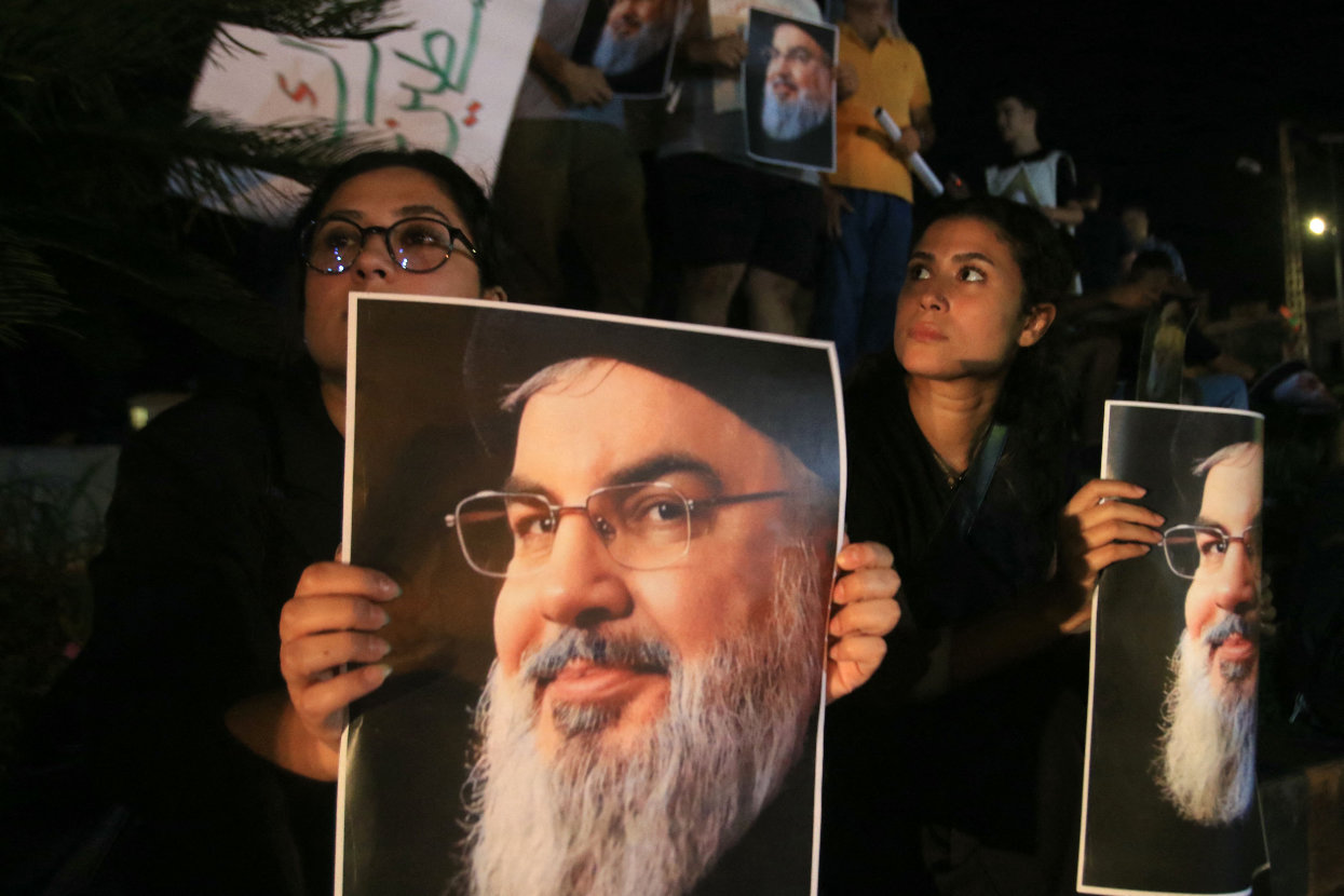 Demonstrators hold pictures of Hassan Nasrallah, late leader of the Lebanese group Hezbollah, on Sept. 28, 2024. (AFP)