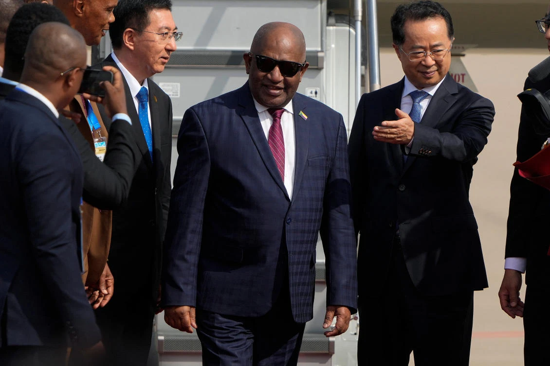 President Azali Assoumani, center, is shown the way by a Chinese official as he arrives at the Beijing Capital International Airport to attend the China Africa Forum, in Beijing, Sunday, Sept. 1, 2024. (REUTERS)