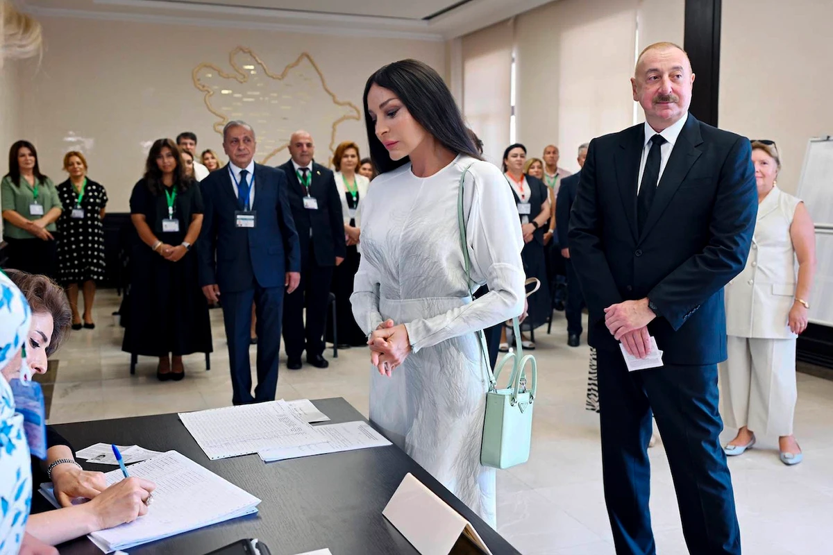 Azerbaijani President Ilham Aliyev, right, and his wife and Vice President Mehriban Aliyeva line up to collect their ballots at a polling station during a snap election in Baku, Azerbaijan, Sunday, Sept. 1, 2024. (AP)