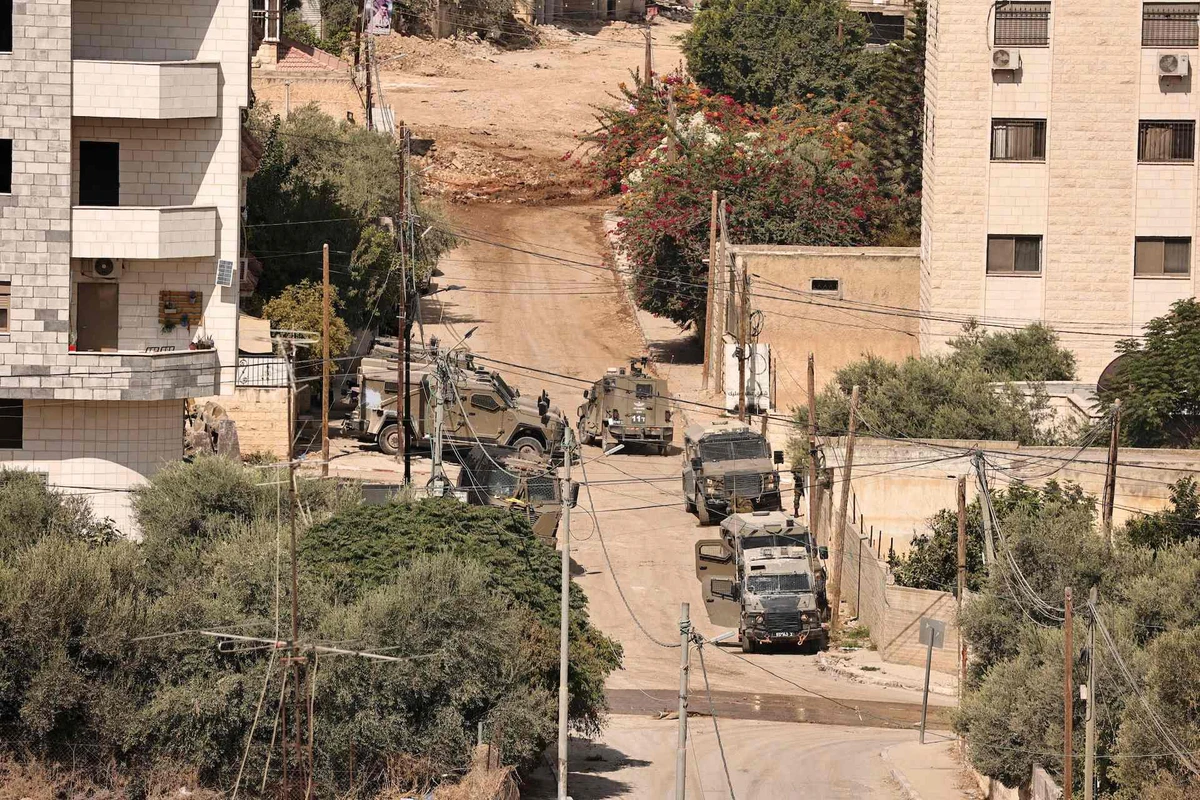 Israeli troops take position in the centre of Jenin during a raid on the Palestinian city on September 3, 2024, amid a large-scale military offensive launched a week earlier in the north of the occupied West Bank. (AFP)