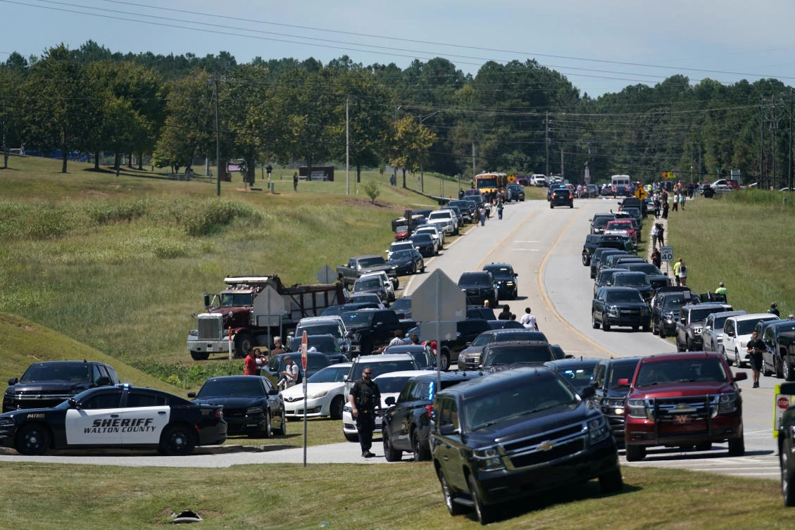 Cars are parked on the sides of a road as law enforcement officers work at the scene of a shooting at Apalachee High School in Winder, Georgia, US Sept. 4, 2024. (Reuters)