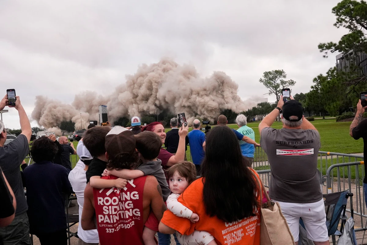 A crowd watches as the Hertz Tower in Lake Charles, Louisiana, is imploded on Sept. 7, 2024. (AP)