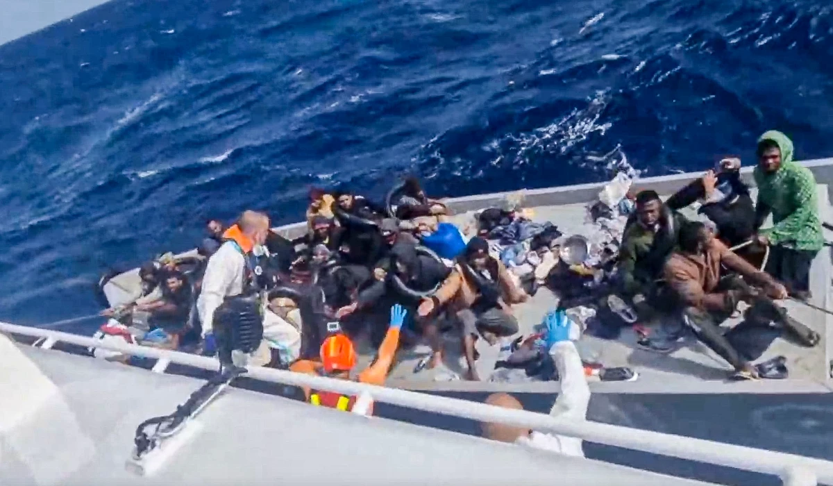 In this image taken from a video released by the Italian Coast Guard on Thursday, April 11, 2024, a boat with migrants is approached by a rescue operation off the island of Lampedusa in the Mediterranean Sea. (AP)