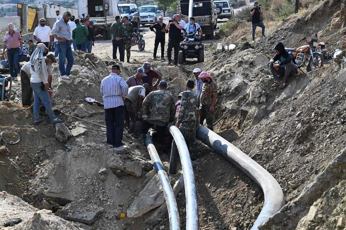 Syrians inspect the damage at the site of overnight Israeli strikes on the outskirts of Masyaf in Syria’s central Hama province on September 9, 2024. (AFP)