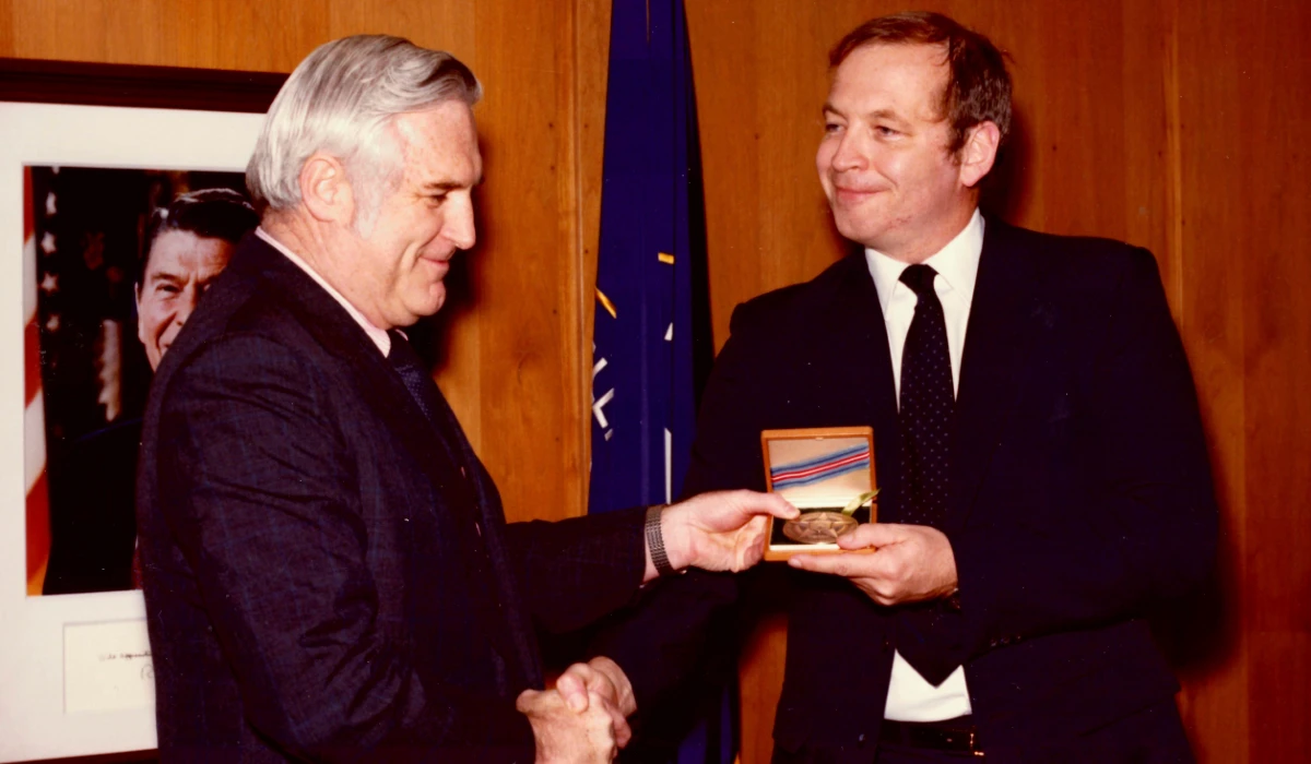 This photograph released by the CIA on behalf of the family of former CIA officer Edward B. Johnson shows Johnson, right, receiving the CIA's Intelligence Star from John N. McMahon, then the agency's deputy director for operations, in May 1980. (AP)
