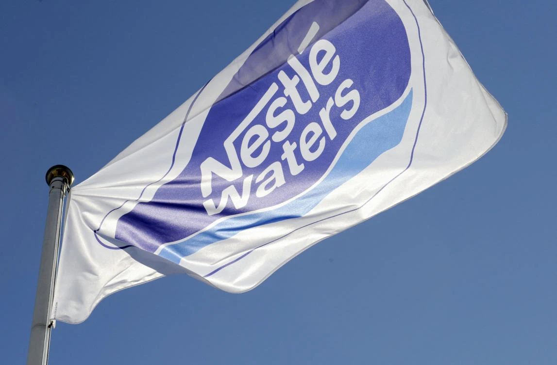 A flag of Nestle Waters Supply est company is seen at the entrance of the mineral water bottling plant of the compay on July 19, 2010 in Vittel, estearn France. (AFP)