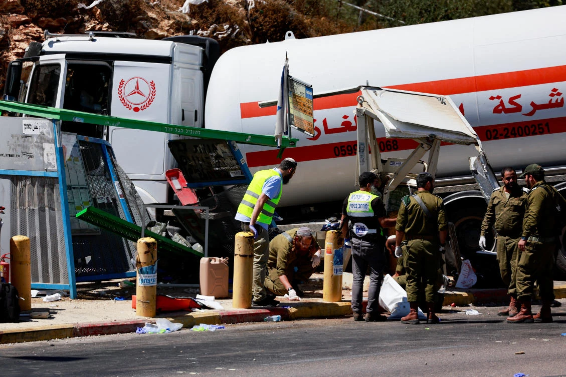 Israeli security and emergency personnel work at the scene of a ramming attack near Givat Assaf settlement, near Ramallah in the Israeli-occupied West Bank, Sept. 11, 2024. (Reuters)