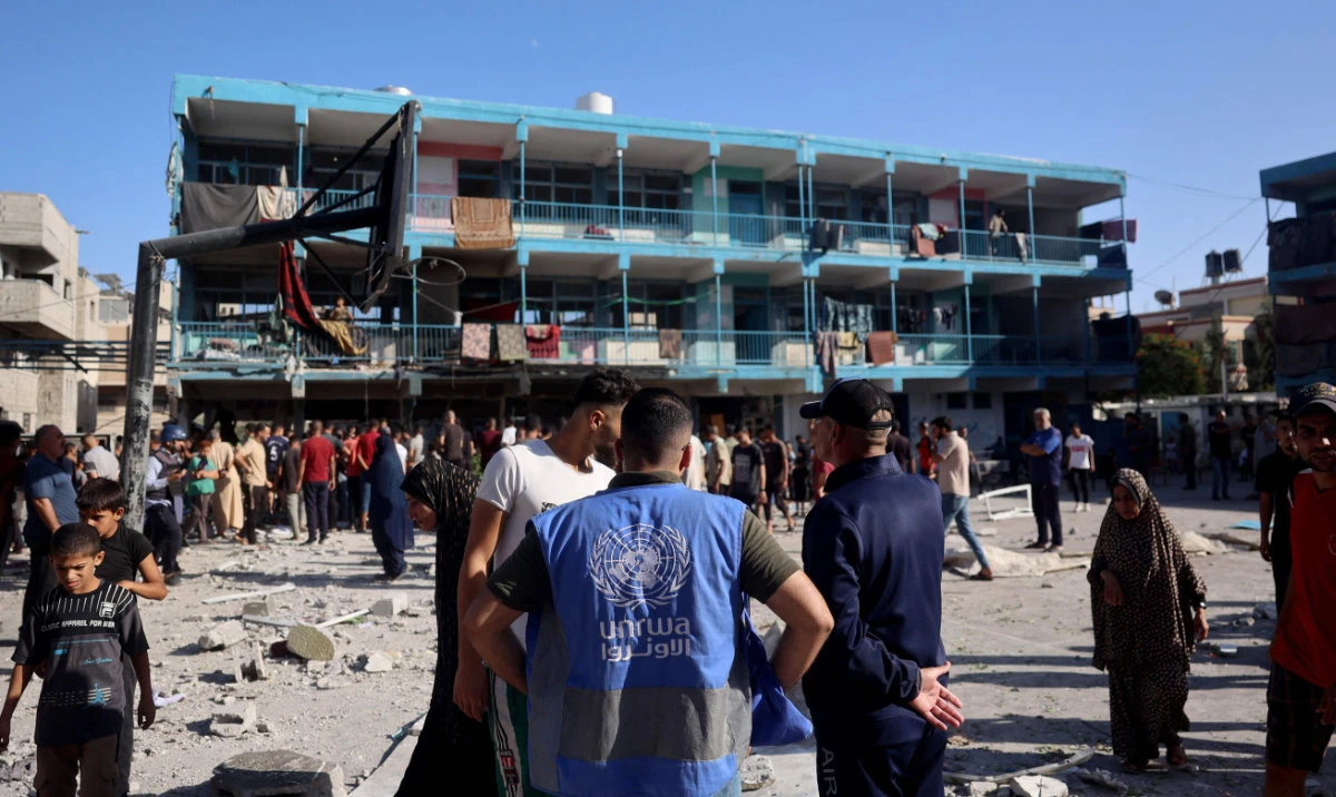 A member of the United Nations Relief and Works Agency for Palestine Refugees (UNRWA) checks the courtyard of a school after an Israeli air strike hit the site, in Nuseirat in the central Gaza Strip on September 11, 2024, amid the ongoing war in the Palestinian territory between Israel and Hamas. (AFP)