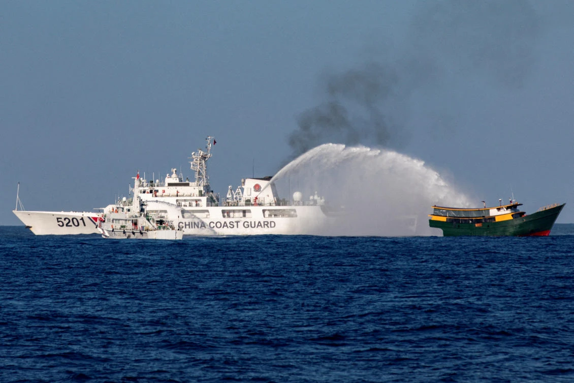 Chinese Coast Guard vessels fire water cannons toward a Philippine resupply vessel Unaizah May 4 on its way to a resupply mission at Second Thomas Shoal in the South China Sea on March 5, 2024. (Reuters)
