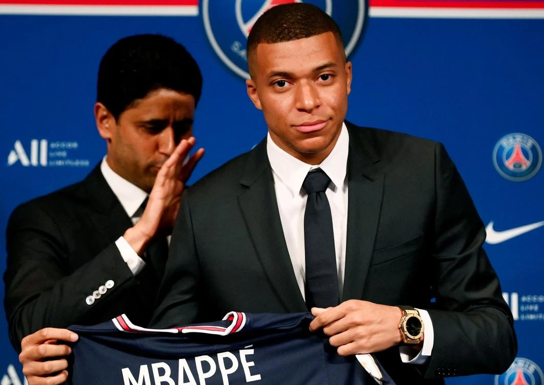 Paris Saint-Germain’s CEO Nasser Al-Khelaifi and French forward Kylian Mbappe pose with a jersey at the end of a press conference at the Parc des Princes stadium in Paris on May 23, 2022. (AFP)