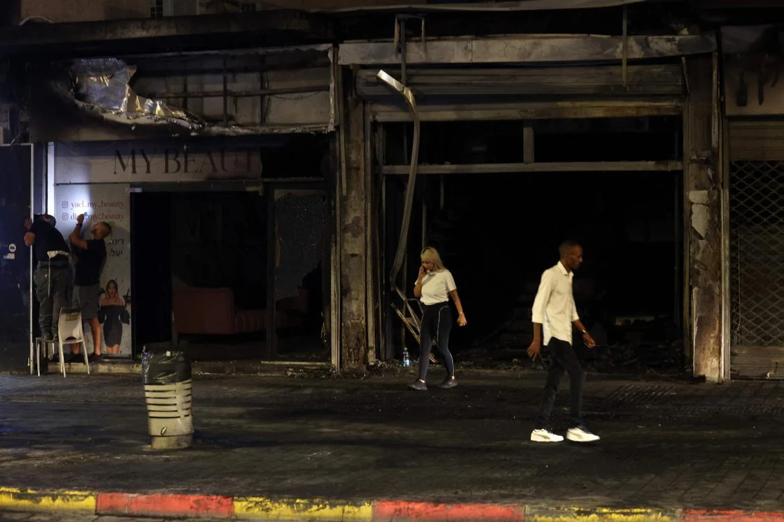 People check the damage at the scene where a vehicle exploded in the central Israeli city of Ramla on Sept. 12, 2024, reportedly killing several people and injuring others. (AFP)