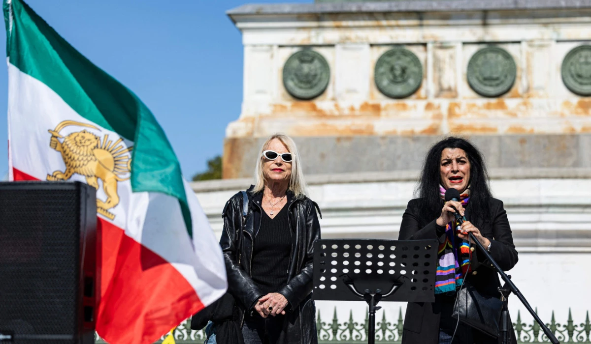 French-Iranian graphic novelist and illustrator Marjane Satrapi (R) delivers a speech next to French journalist Laure Adler (L) during a march on the second anniversary of a protest movement sparked by the death in custody of Mahsa Amini, 22, arrested for allegedly violating the dress code for women at Place de la Bastille, in Paris on September 15, 2024. (AFP)