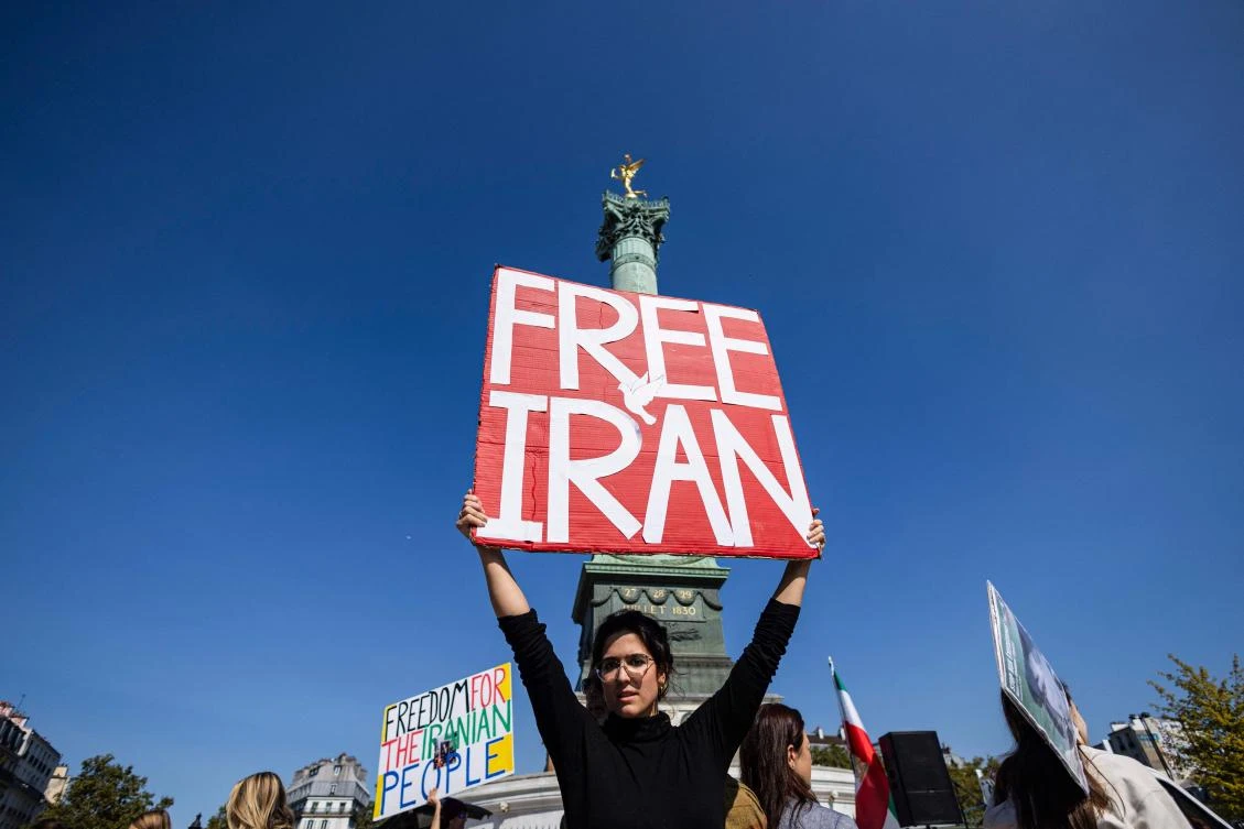 A protester holds a placard as she takes part in a march on the second anniversary of a protest movement sparked by the death in custody of Mahsa Amini, 22, arrested for allegedly violating the dress code for women at Place de la Bastille, in Paris on September 15, 2024. (AFP)