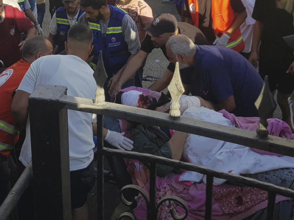 Civil Defense first-responders carry a man who was wounded after his handheld pager exploded, in the southern port city of Sidon, Lebanon, on Sept. 17, 2024.(AP)