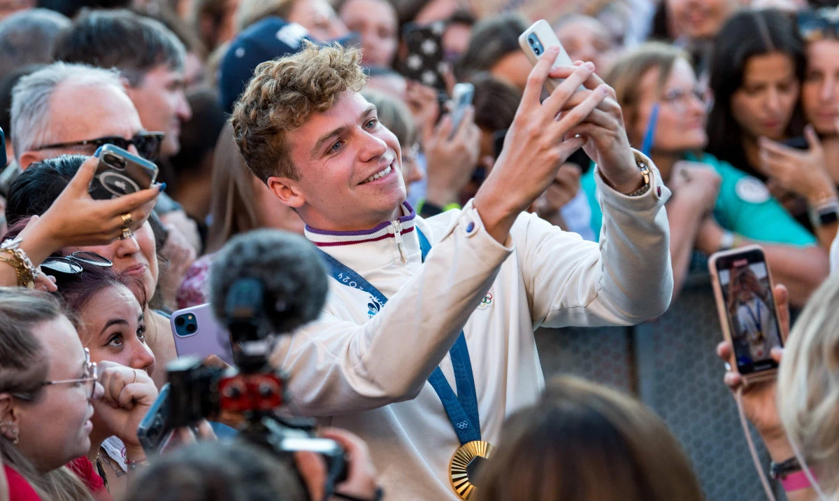 Leon Marchand, four-times gold medallist French swimmer celebrates with the people of Toulouse during a ceremony for Toulouse's Olympic medalists in the Place de Capitole, in Toulouse, southwestern France, on Wednesday. (AFP)