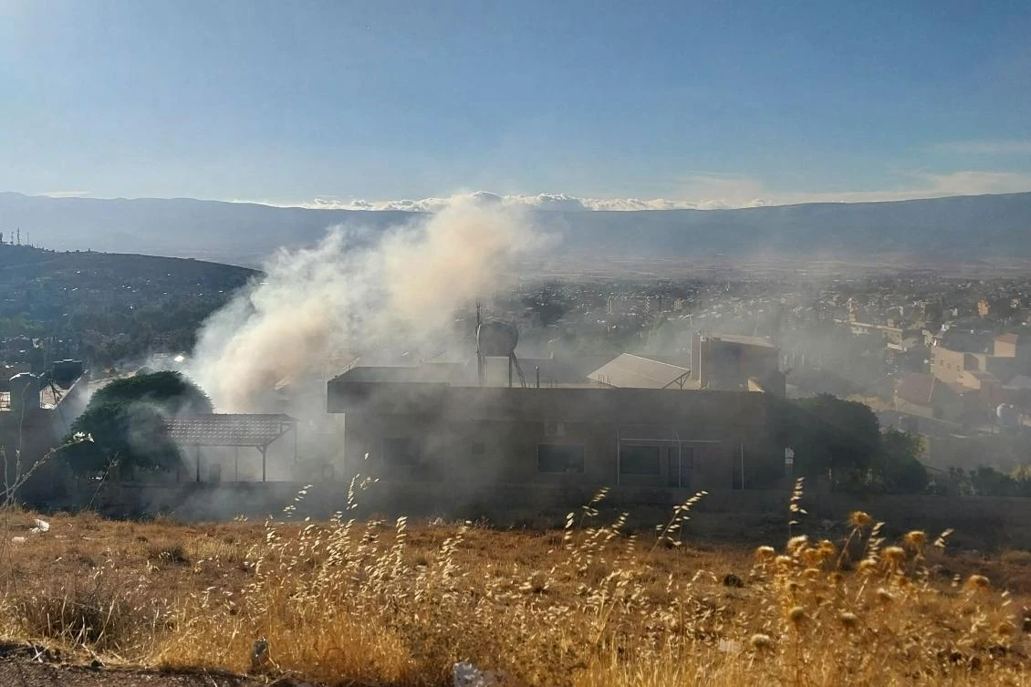 Smoke billows from a house in Baalbek in east Lebanon after a reported explosion of a radio device, on Sept. 18, 2024. (AFP)