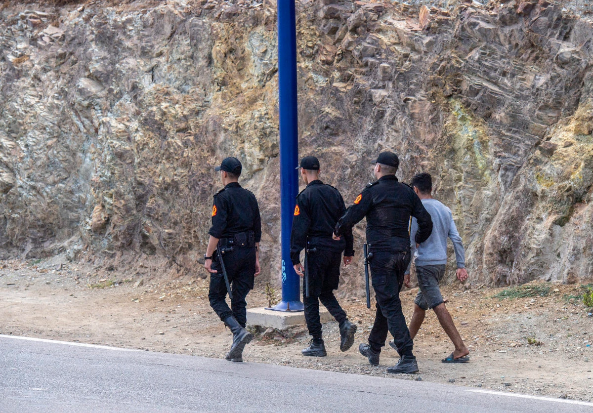 Moroccan security forces detain a boy attempting to cross the border with the Spanish enclave of Ceuta, in Fnideq, Morocco,on Sept. 16, 2024. (AP Photo)