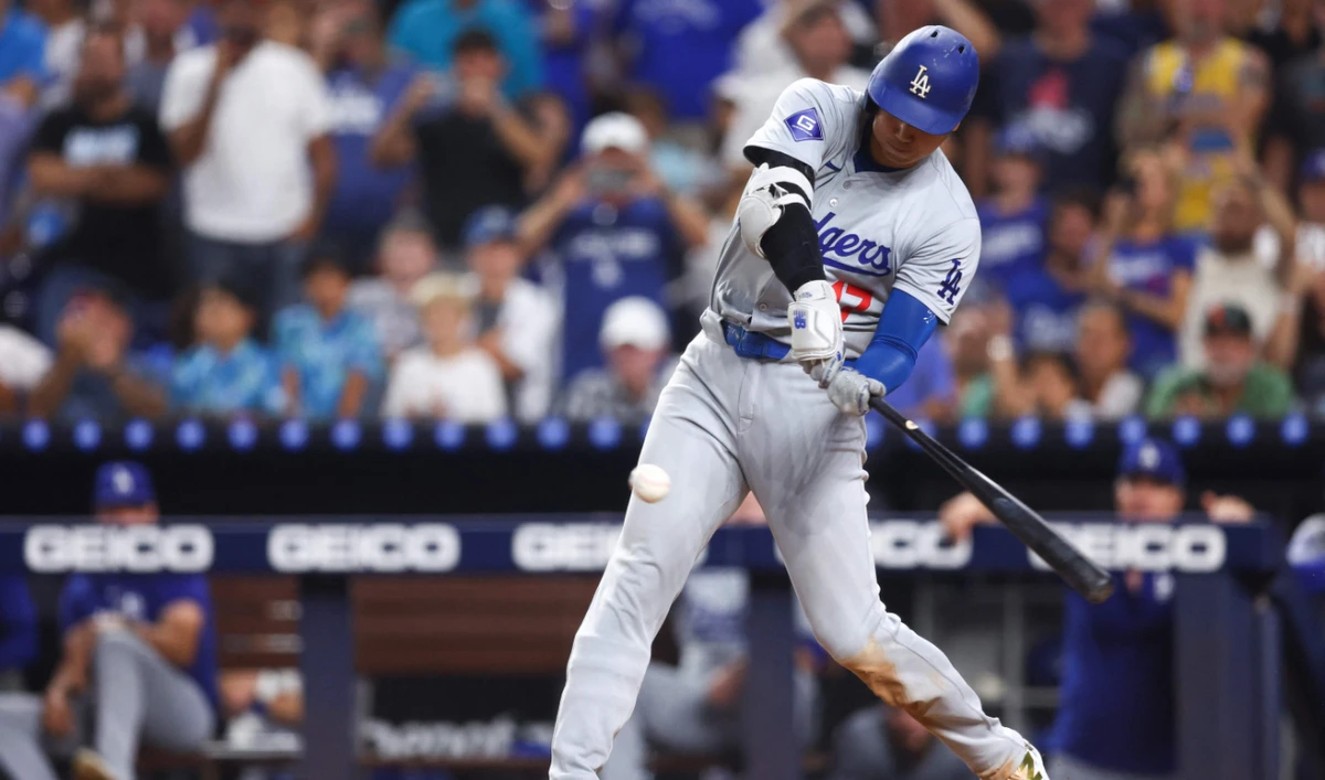 Shohei Ohtani of the Los Angeles Dodgers hits a two-run home run, his 50th of the season, becoming the first player with a 50/50 season in MLB history, during the seventh inning against Miami Marlins at loanDepot park on Sept. 19, 2024. (AFP)