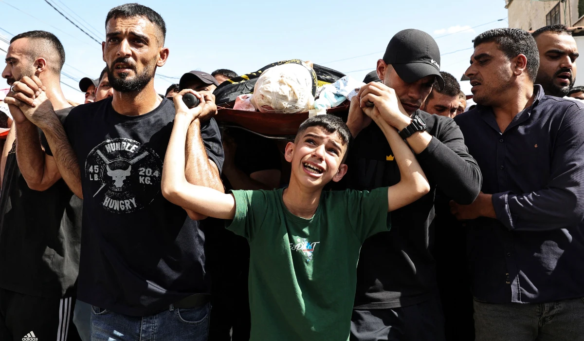 Mourners attend Friday’s funeral of Palestinian men killed during an Israeli military raid in Qabatiyah, south of Jenin in the occupied West Bank. The military has been carrying out large-scale raids in Qabatiyah. (AFP)