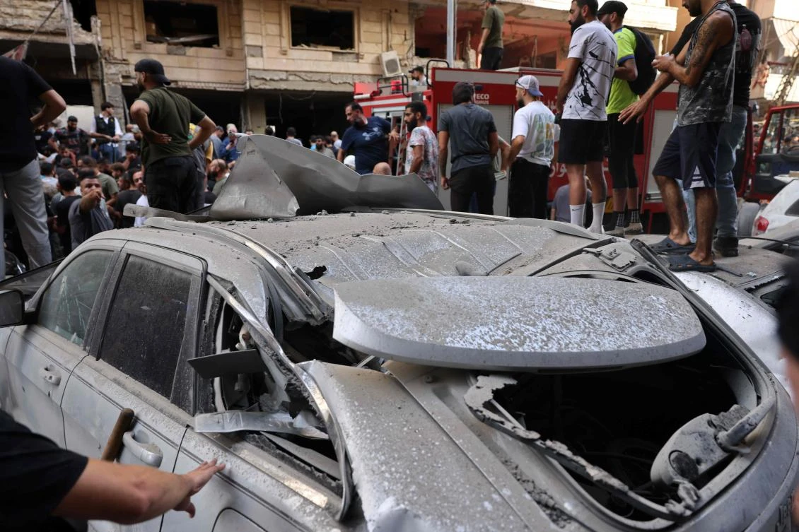 People check the damage following an Israeli strike in Beirut's southern suburbs on September 20, 2024. The Israeli military announced that the commander of Hezbollah's elite Radwan unit, Ibrahim Aqil, and other senior figures of the Lebanese armed group had been killed in the air strike. (AFP)