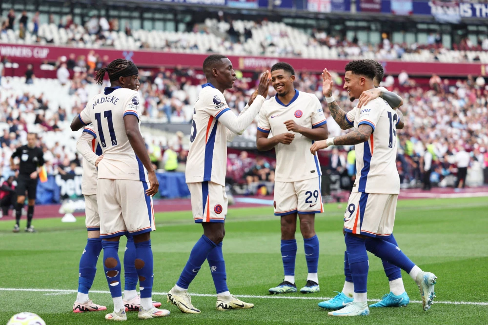 Chelsea players celebrate after scoring their third goal. (AFP)