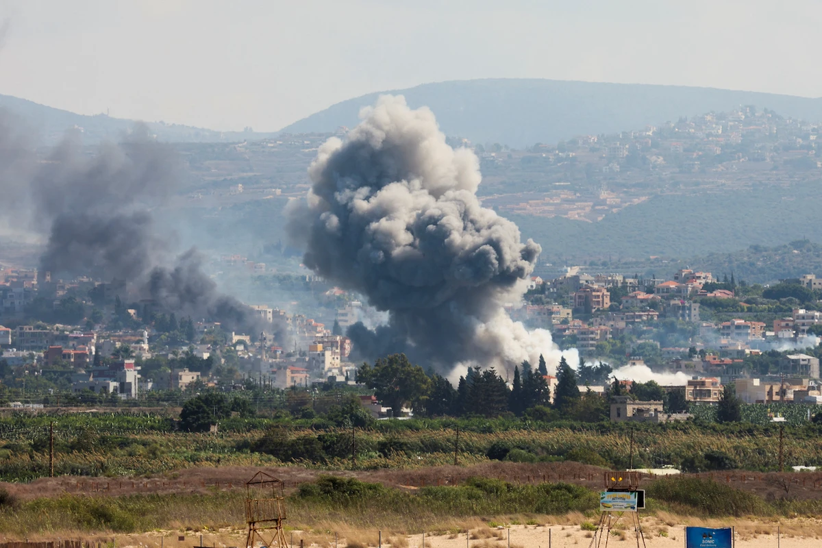 Smoke billows over southern Lebanon following Israeli strikes, amid ongoing cross-border hostilities between Hezbollah and Israeli forces, as seen from Tyre on September 23, 2024. (Reuters)