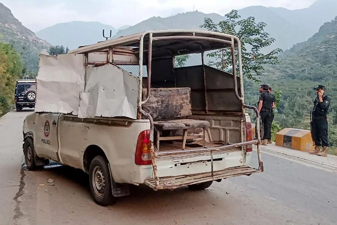 Security personnel stand near a damaged police vehicle at the site of a bomb explosion, in Malam Jabba at Swat district of Khyber Pakhtunkhwa province on September 22, 2024. (AFP)