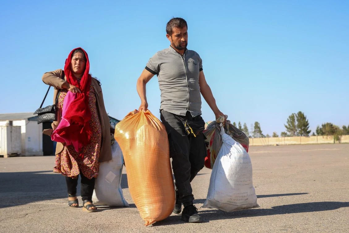 These refugees in counterfeit Fendi or Dior T-shirts are registered by the Afghan authorities and examined by the International Organization for Migration (IOM). (AFP)
