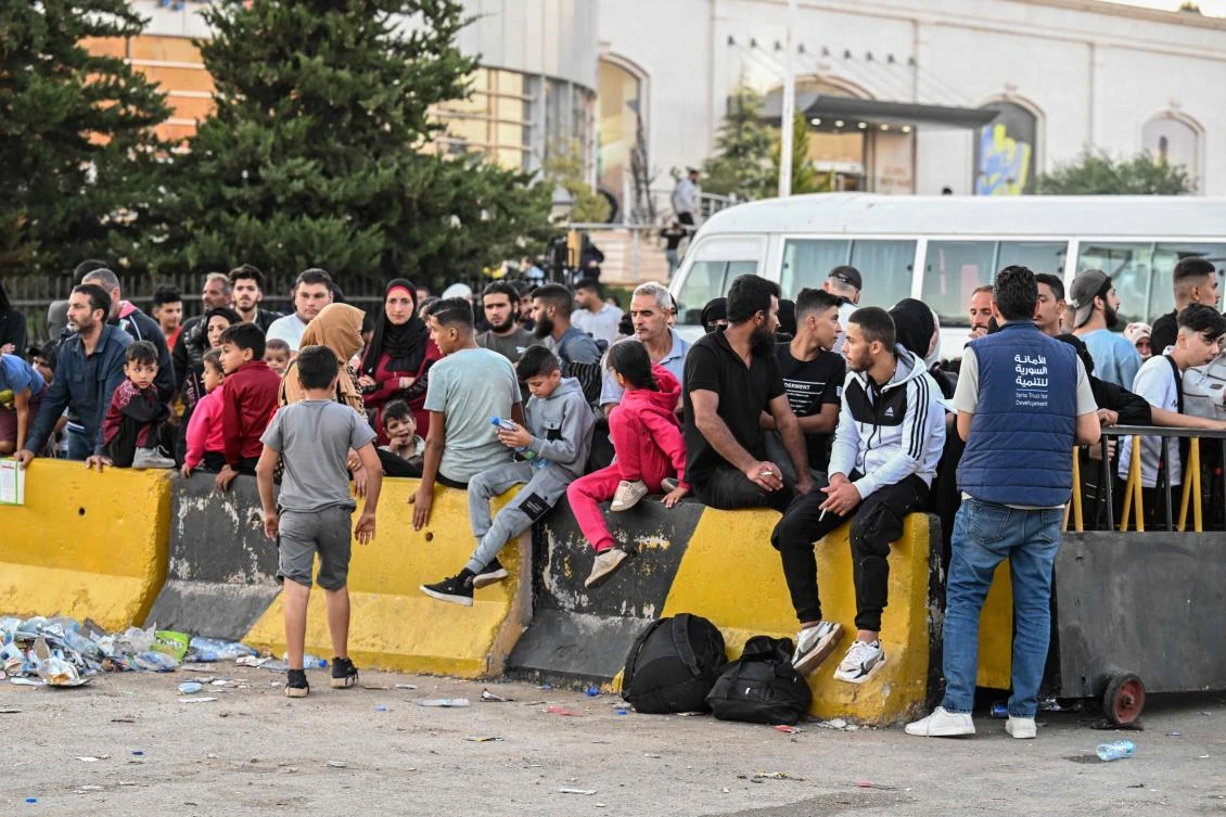 People fleeing from Lebanon arrive on the Syrian side of the border with Lebanon in Jdeidat Yabus in southwestern Syria on Sept. 25, 2024. (AFP)