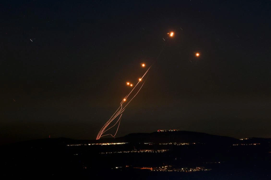 Rockets fired from southern Lebanon are intercepted by Israel’s Iron Dome air defense system over the Upper Galilee region in northern Israel on Sept. 27, 2024. (AFP)