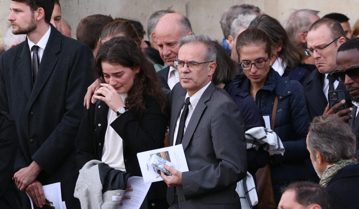 Relatives of Philippine, a French student, whose body was found buried nearly a week ago cry after her funeral ceremony at Versailles' cathedral near Paris, on September 27, 2024. (AFP)