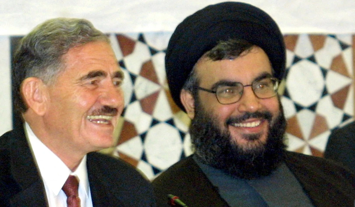 Sheikh Hasan Nasrallah, Secretary General of the Hezbollah (R) shares a light moment with Abdullah al-Ahmar deputy Secretary General of the Syrian ruling Baath party during a conference of extremist Arab and Islamist movements in Damascus on September 27, 2001. (AFP)