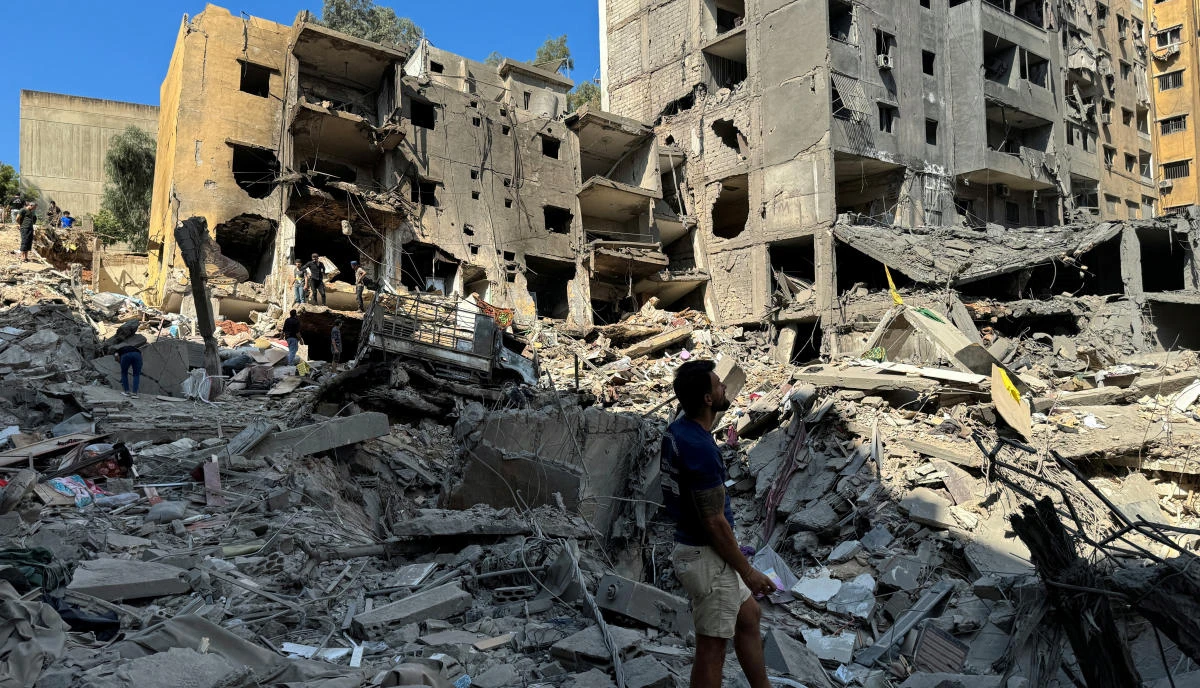 A man stands at the site of the Israeli air strike that killed Lebanon's Hezbollah leader Sayyed Hassan Nasrallah on Friday, in Beirut's southern suburbs, Lebanon. (Reuters)