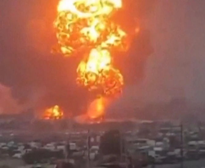 An image grab taken from a UGC video posted on social media on September 29, 2024, shows smoke billowing above Hodeida port city following Israeli strikes. (AFP)