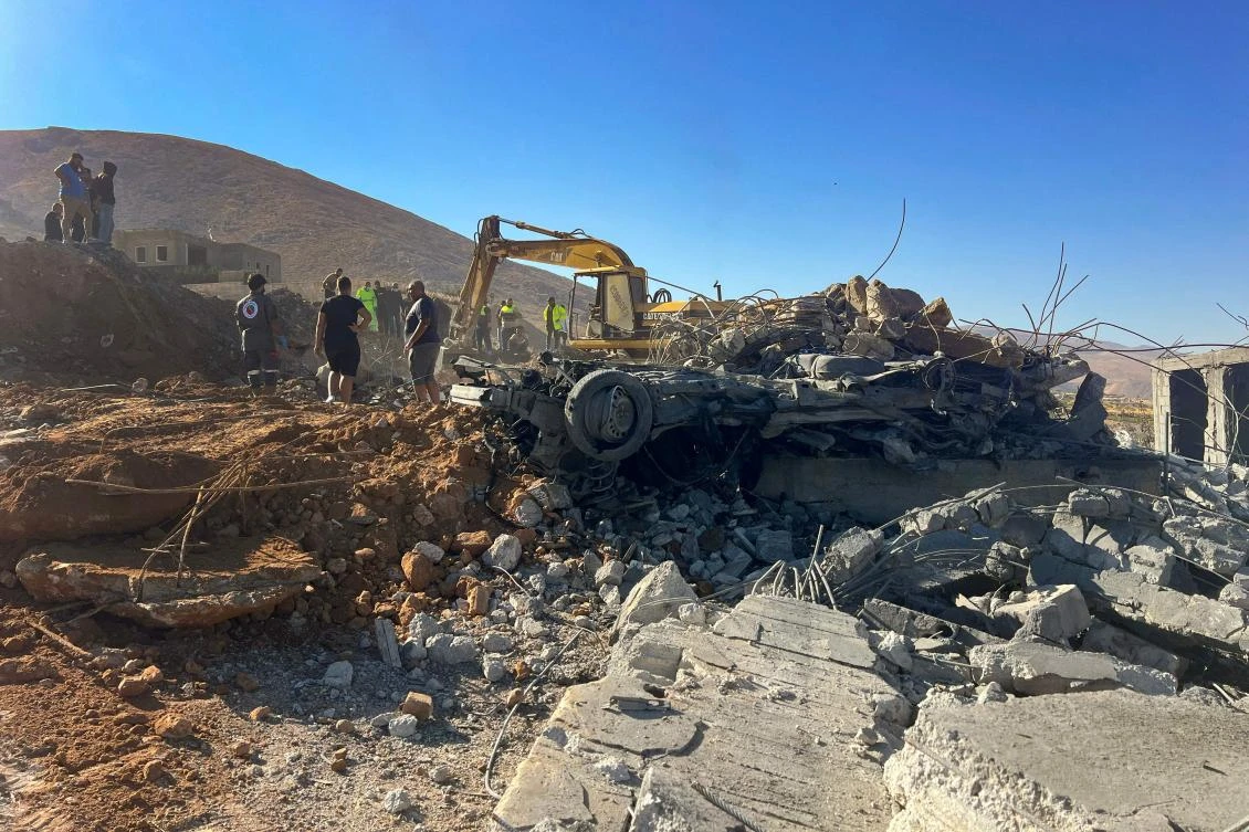 Rescuers remove the rubble of a house levelled overnight by an Israeli airstrike that targeted the village of a El-Ain in Lebanon's eastern Bekaa valley on September 29, 2024. (AFP)