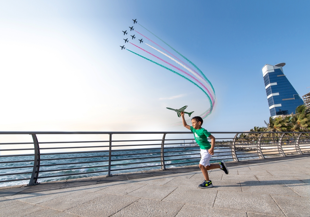 A boy on the Saudi National Day and the air show on the Jeddah Corniche. Shutterstock