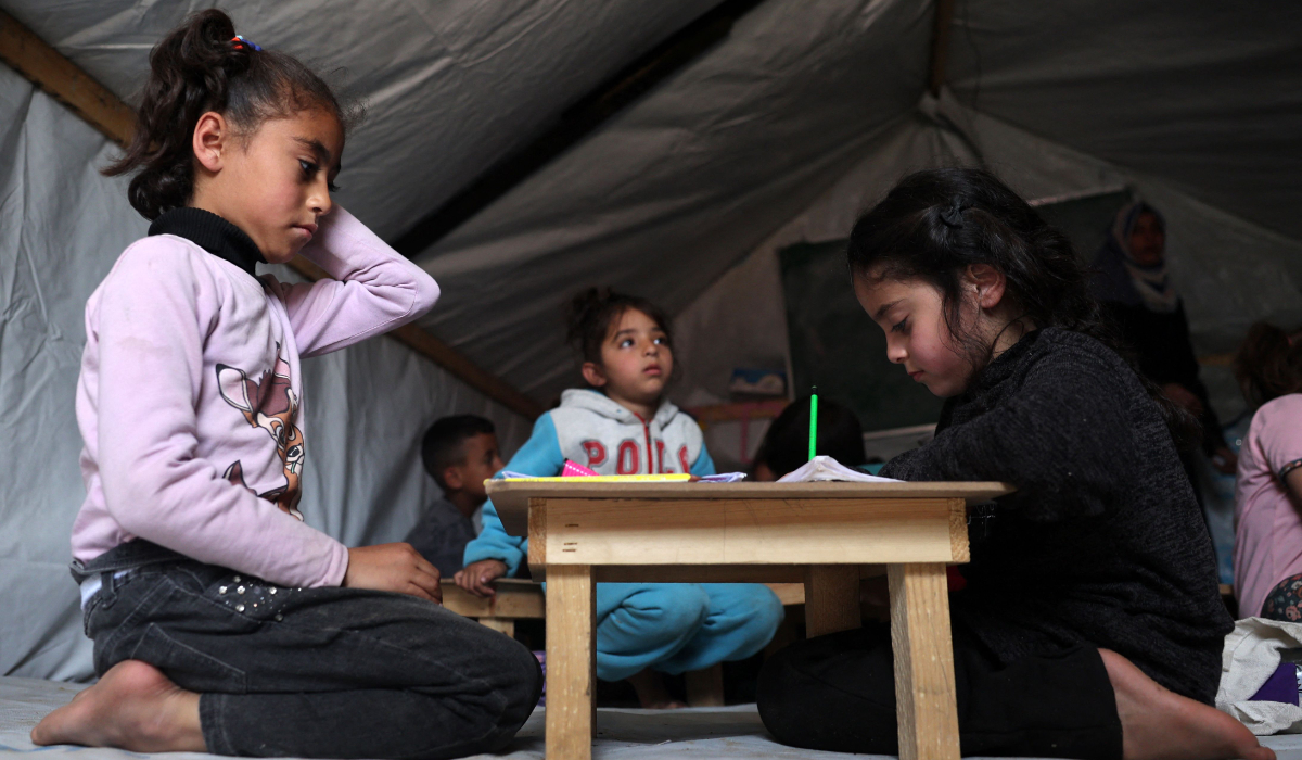 Children attend class at a makeshift classroom in a camp for displaced Palestinians in Rafah, in the southern Gaza Strip. (AFP)
