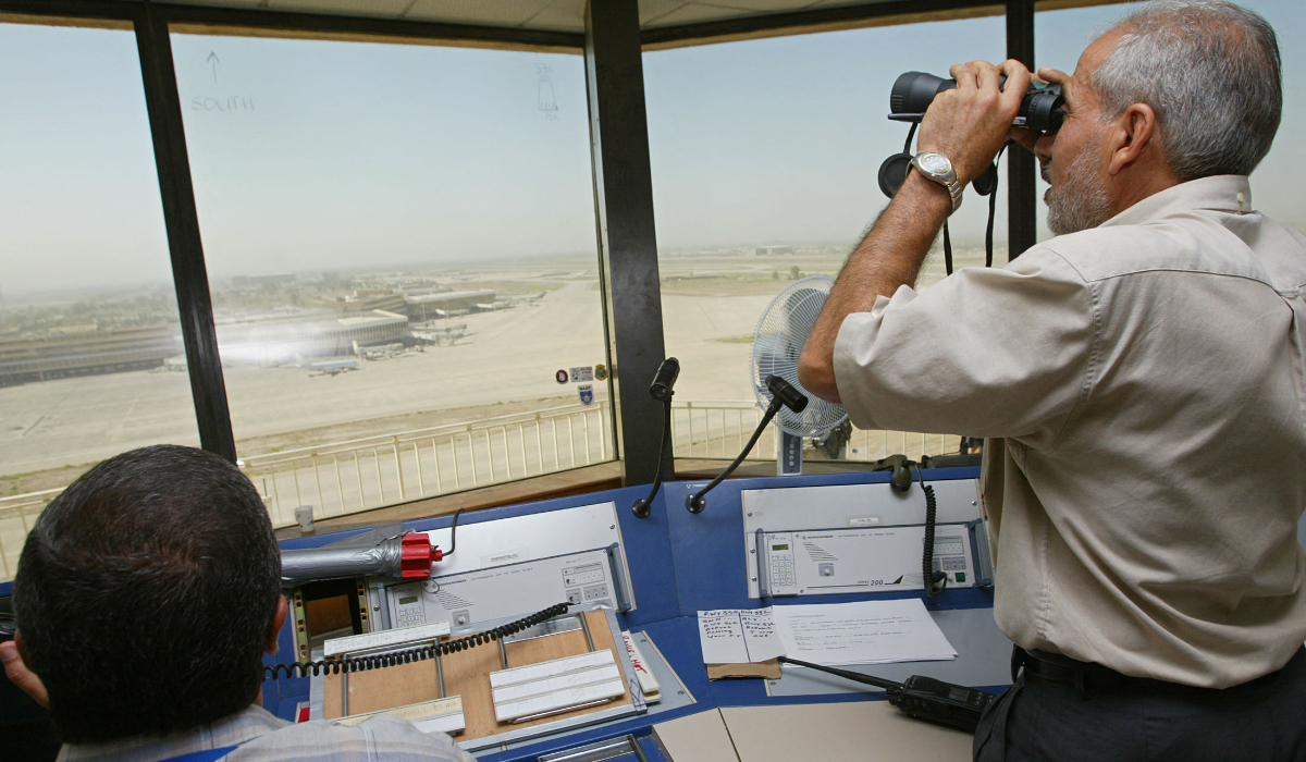 Two Iraqi flight controllers monitor air traffic from the tower of Baghdad International Airport. (AFP file photo)