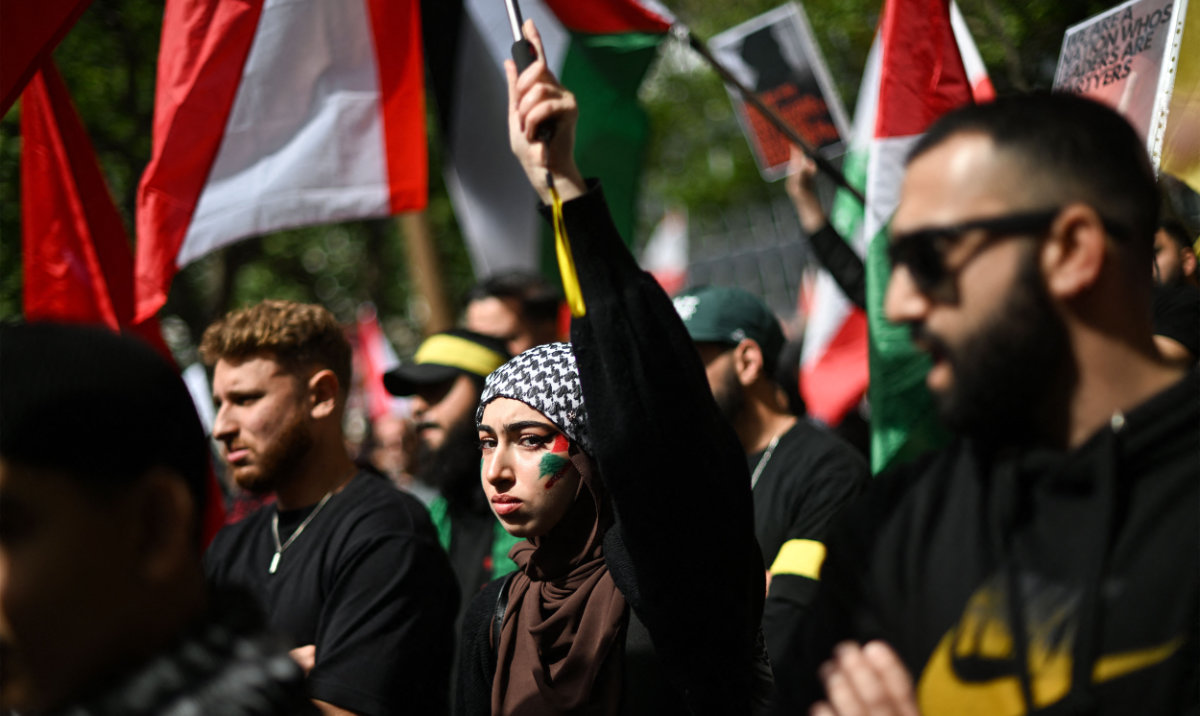 Demonstrators march through the streets against Israeli strikes in Gaza and Lebanon at a protest rally in the central business district of Sydney on September 29, 2024. (AFP)